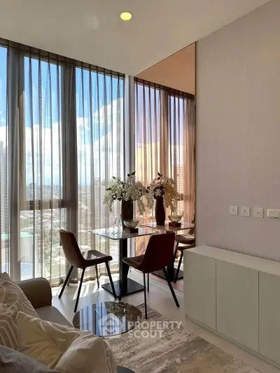 Modern living room with floor-to-ceiling windows and city view, featuring elegant decor and natural light.