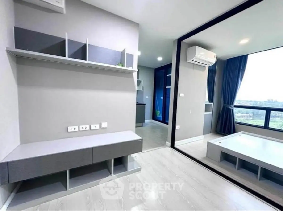 Modern apartment interior with sleek design and large windows offering a stunning view.
