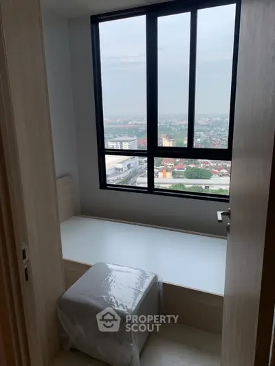 Cozy small room with window seat offering panoramic city view