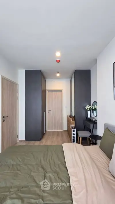 Modern bedroom with stylish decor and cozy bedding in a contemporary apartment.