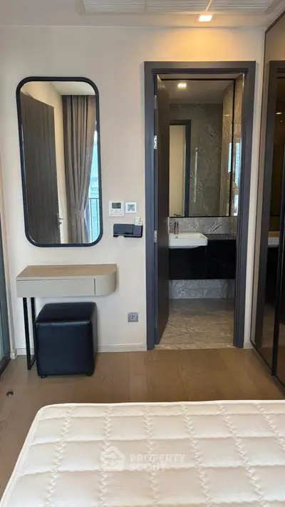 Modern bedroom with ensuite bathroom and stylish vanity area.