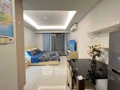 Modern studio apartment with sleek design, featuring a cozy bed, dining area, and flat-screen TV.