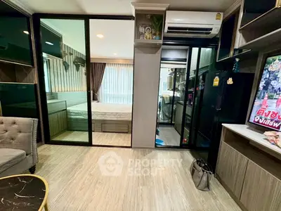 Modern apartment interior with open layout, featuring a cozy living area and a glimpse of the bedroom.