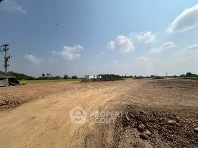 Expansive land plot with clear skies, ideal for development opportunities.