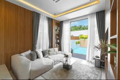 Luxurious living room with pool view, modern decor, and elegant furnishings.