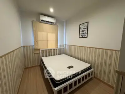 Cozy bedroom with modern decor and air conditioning, perfect for restful nights.