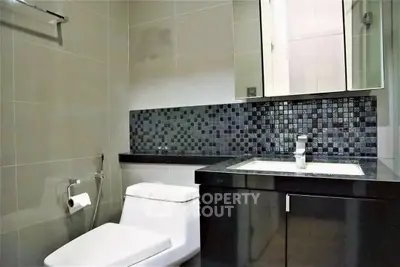 Modern bathroom with sleek black tiles and contemporary fixtures