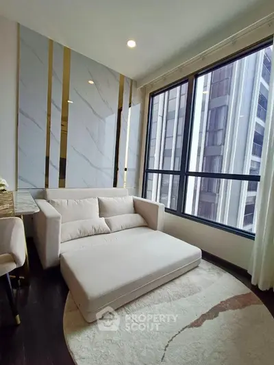 Luxurious corner unit living room with large sectional sofa, marble walls, and expansive windows offering city views, perfect for upscale urban living.