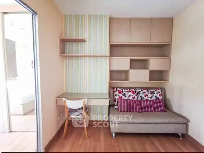 Cozy study nook with built-in shelves and stylish sofa in modern apartment