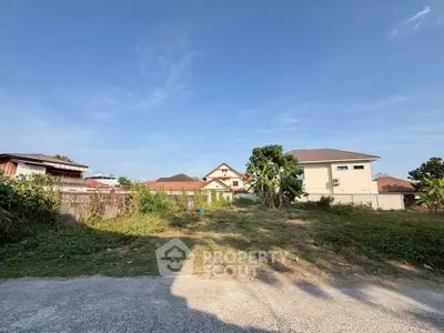 Spacious land plot with clear sky and mountain view, ideal for building a dream home in a serene neighborhood.