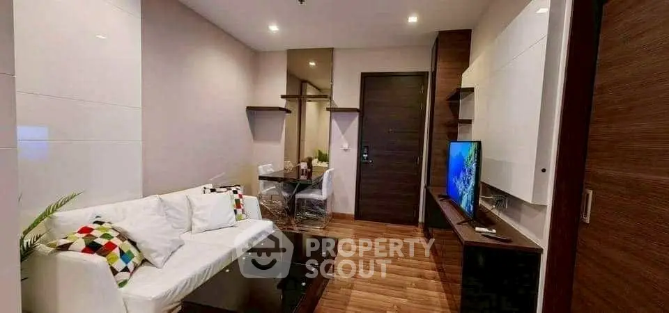 Modern living room with stylish decor and sleek furniture in a cozy apartment.