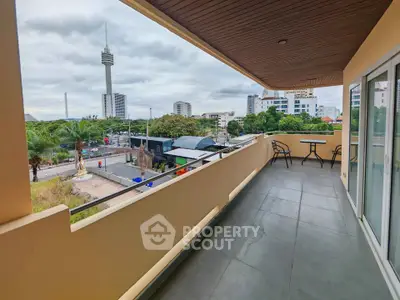 Spacious balcony with city view, perfect for relaxation and outdoor dining.