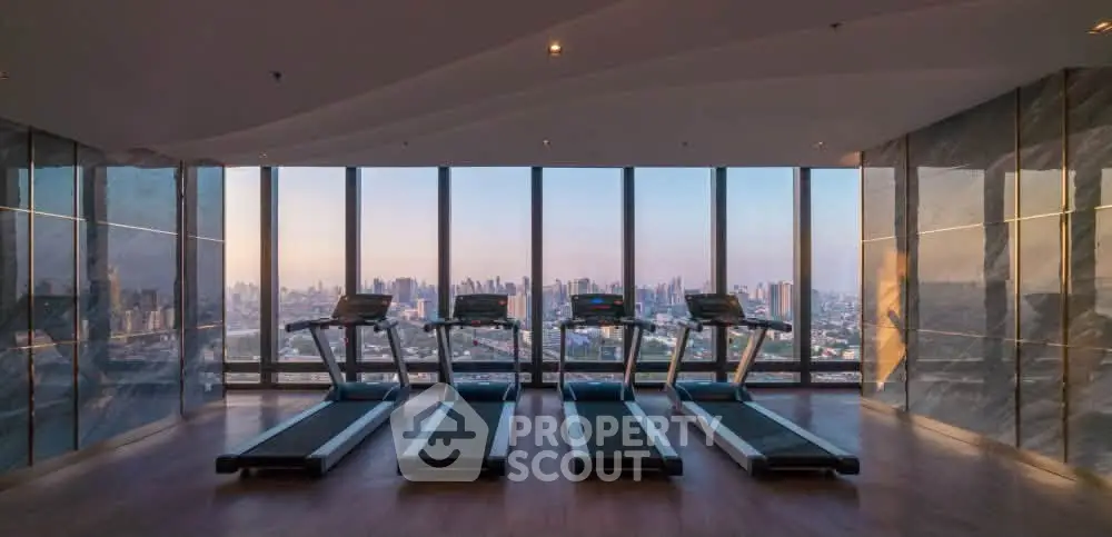 Luxurious high-rise gym with panoramic city views and modern treadmills.