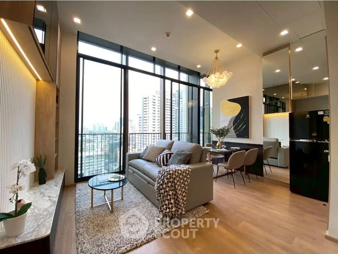 Luxurious modern living room with floor-to-ceiling windows and stunning city view.