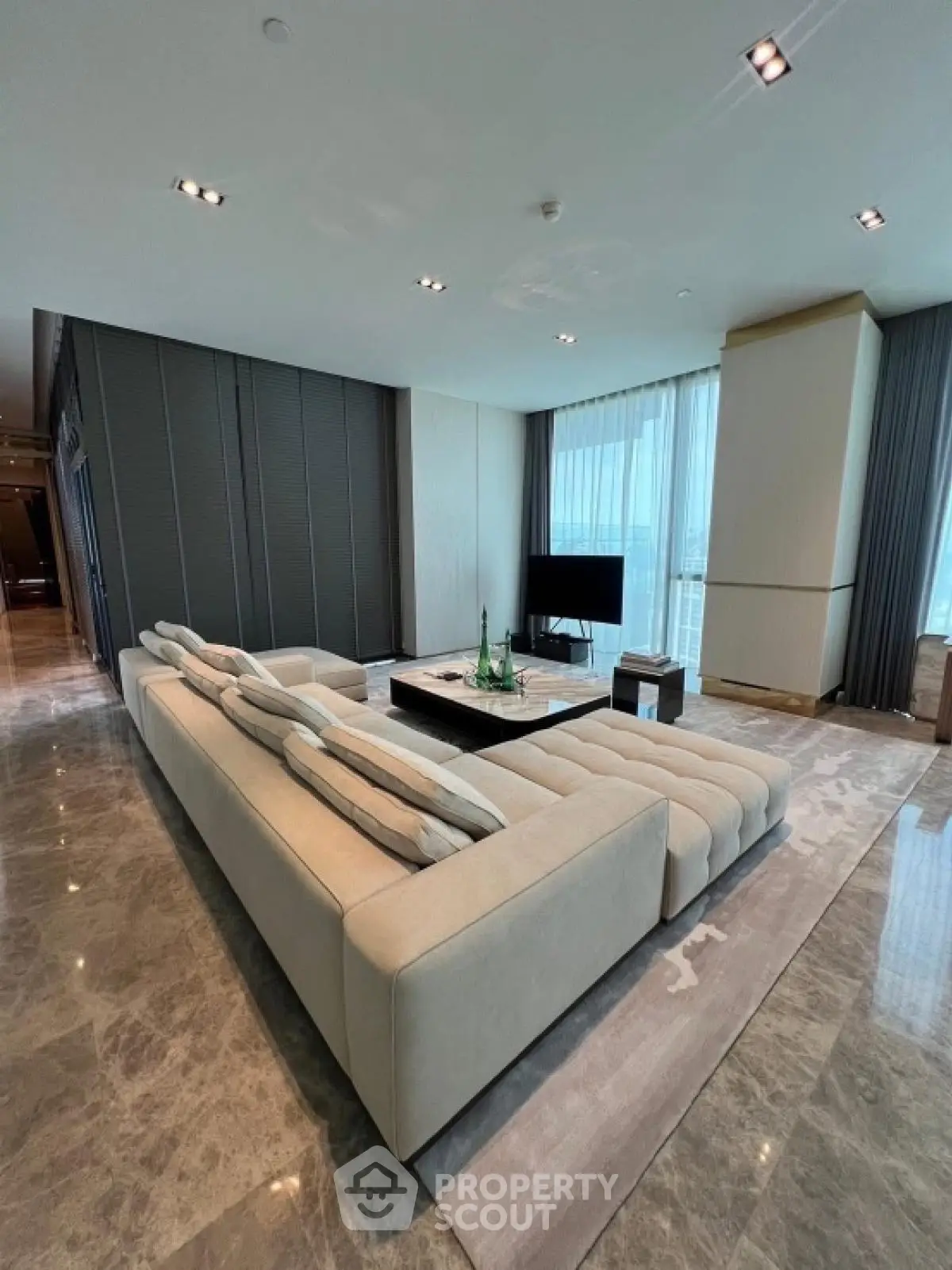 Luxurious modern living room with plush sectional sofa and marble flooring