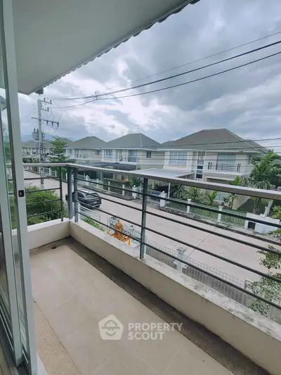 Spacious balcony with scenic neighborhood view in modern residential area.