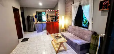Cozy living room with modern decor and open kitchen layout, perfect for relaxation and entertaining.