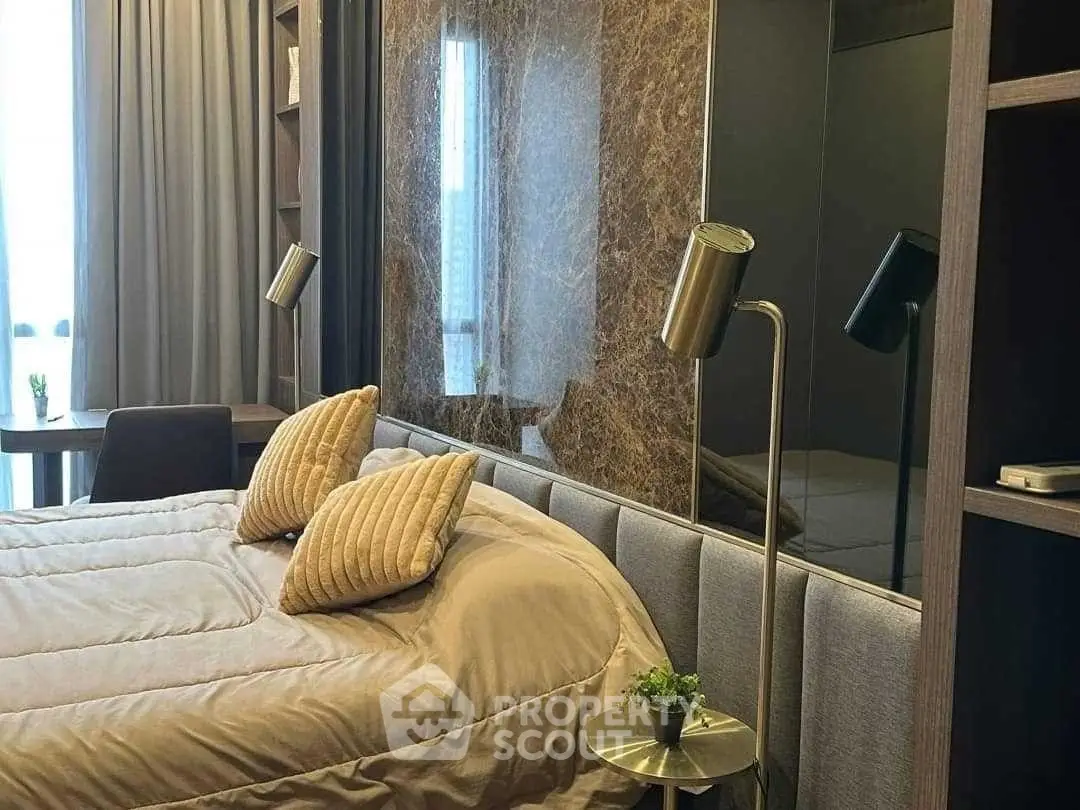 Luxurious bedroom with elegant decor and modern lighting in a stylish apartment.