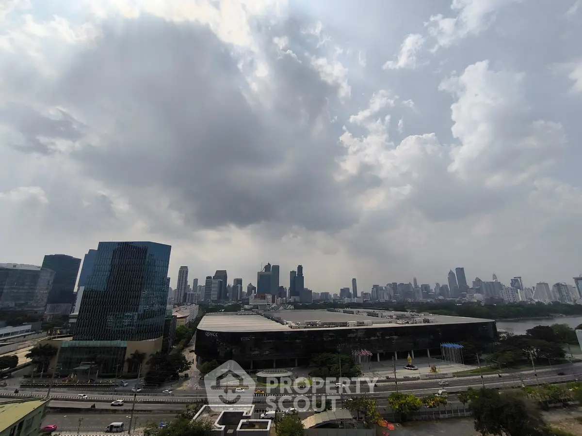 Stunning city skyline view with modern skyscrapers under a dramatic cloudy sky.