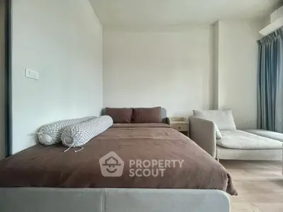 Cozy bedroom with modern decor and comfortable seating area