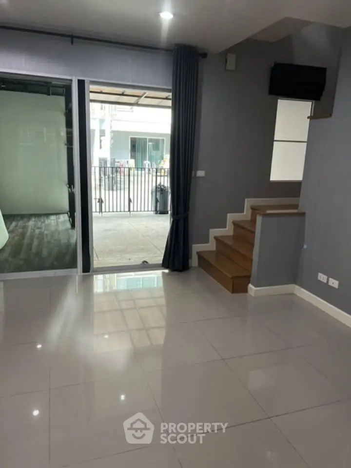 Modern interior with sleek staircase and large windows in a contemporary home.