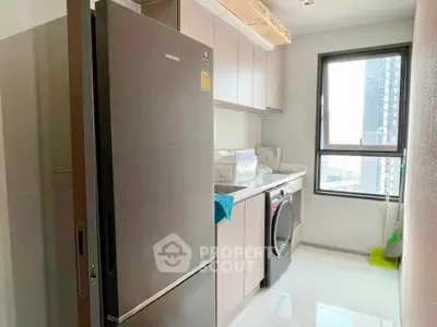 Modern kitchen with sleek appliances and city view window