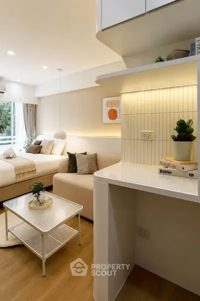 Modern living room with cozy decor and natural light, featuring a stylish sofa and elegant shelving.