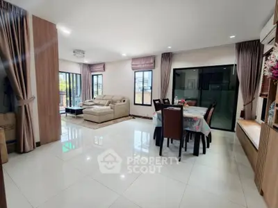 Spacious modern living and dining area with elegant decor and natural light.