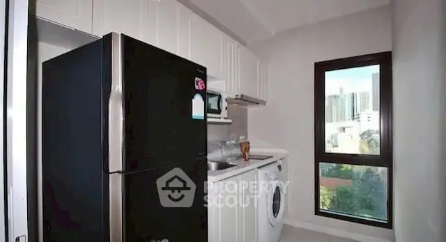 Modern kitchen with sleek appliances and city view window