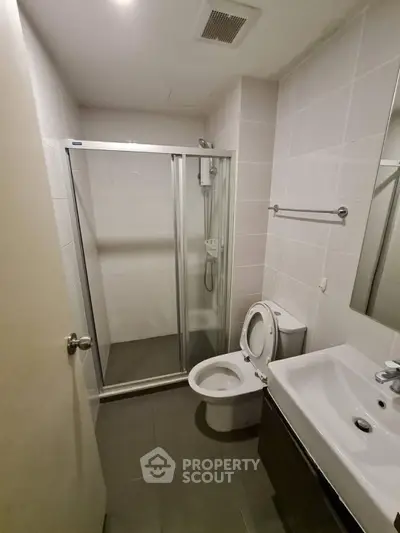 Modern bathroom with glass shower enclosure and sleek fixtures