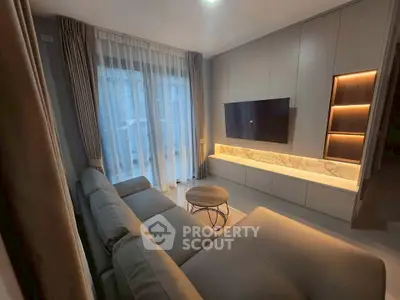 Modern living room with sleek design, featuring a cozy sofa and wall-mounted TV.