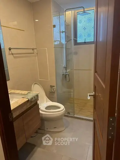 Modern bathroom with glass shower and elegant fixtures in a stylish home.
