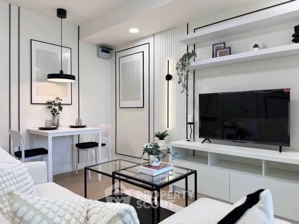 Modern living room with sleek decor, wall-mounted TV, and stylish dining area in open layout.