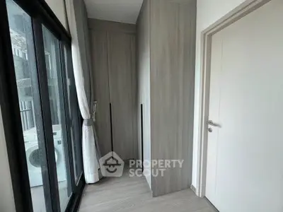Modern apartment with sleek storage and large windows for natural light