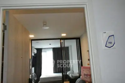 Modern bedroom with sliding glass doors and cozy decor in a stylish apartment.