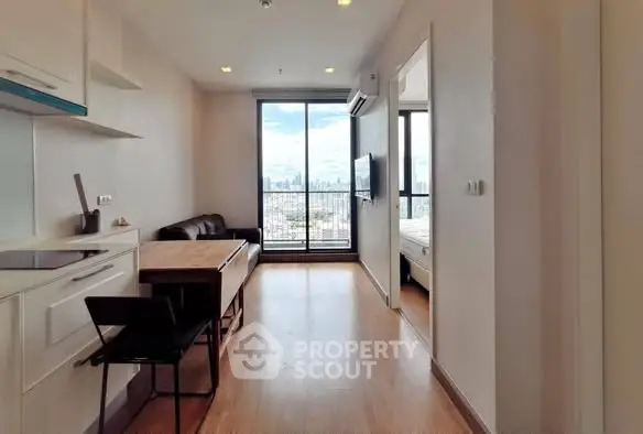 Modern apartment with open layout and stunning city view from balcony.