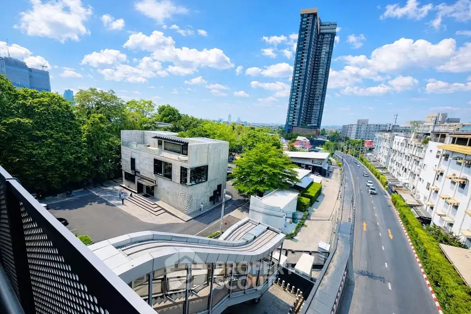 Stunning urban view with modern high-rise and lush greenery, perfect for city living enthusiasts.