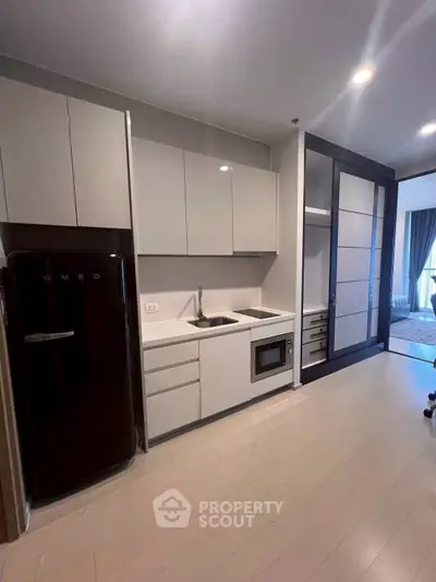 Modern kitchen with sleek cabinetry and built-in appliances in a stylish apartment.
