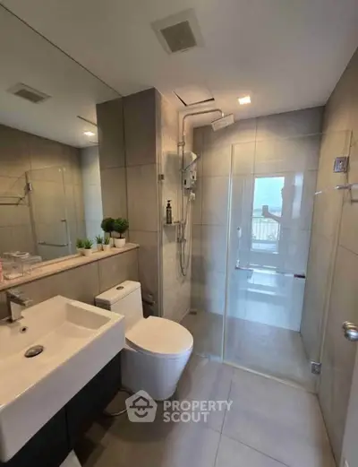 Modern bathroom with sleek fixtures and glass shower enclosure