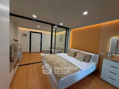 Modern bedroom with elegant decor and cozy ambiance in a stylish apartment.