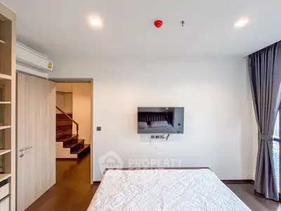 Modern bedroom with wall-mounted TV and elegant decor