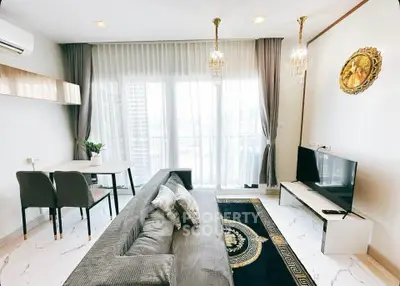 Elegant living room with modern decor, plush sofa, and floor-to-ceiling windows offering natural light.