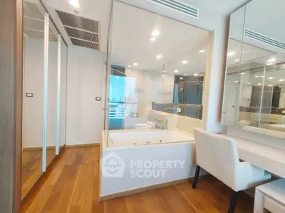 Luxurious bathroom with elegant bathtub and mirrored walls in modern apartment