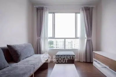 Modern living room with large window and stylish furniture