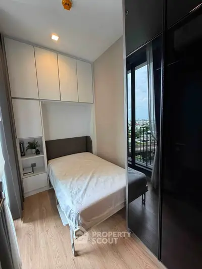Cozy bedroom with modern design and large window offering city view