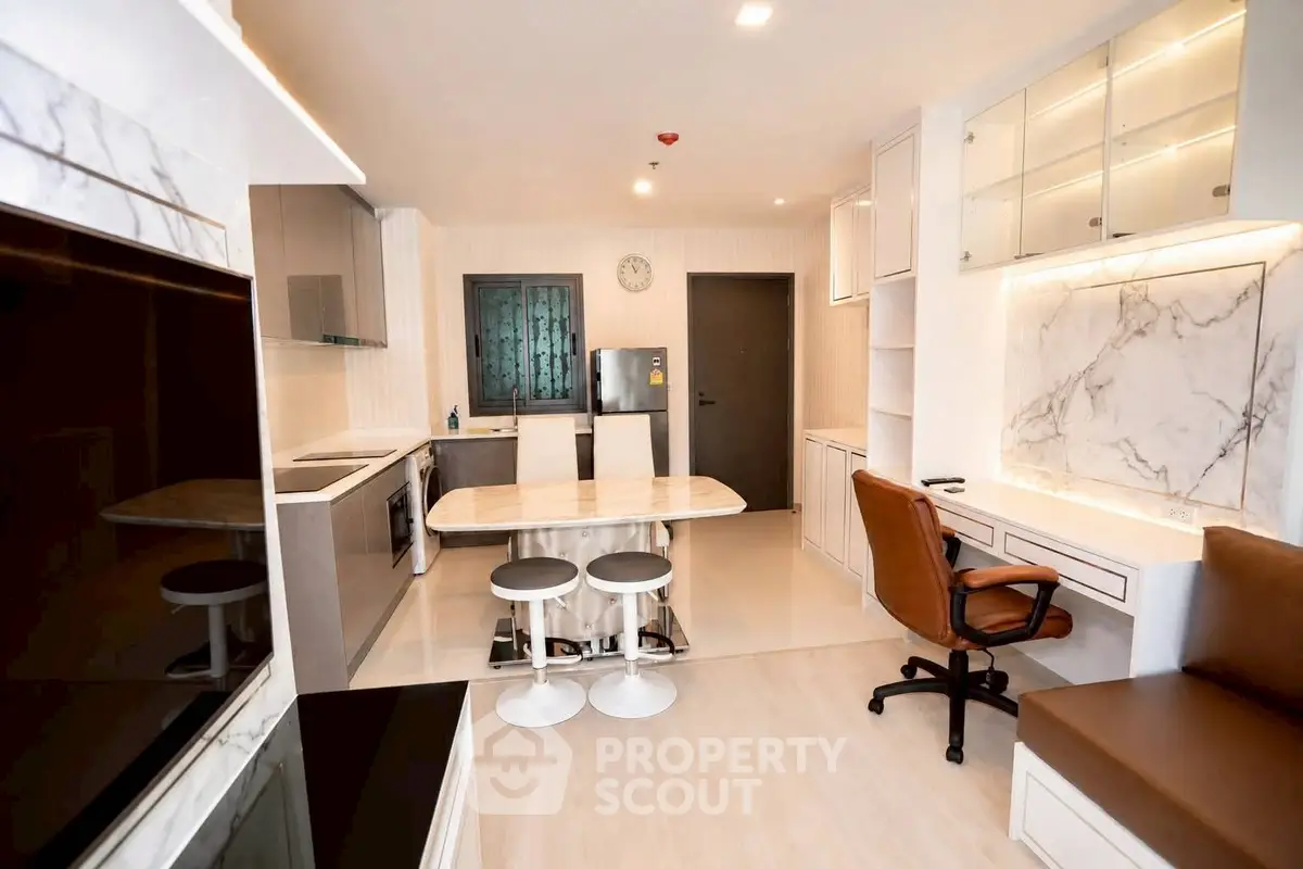Modern kitchen with marble countertops and sleek appliances in a stylish apartment.
