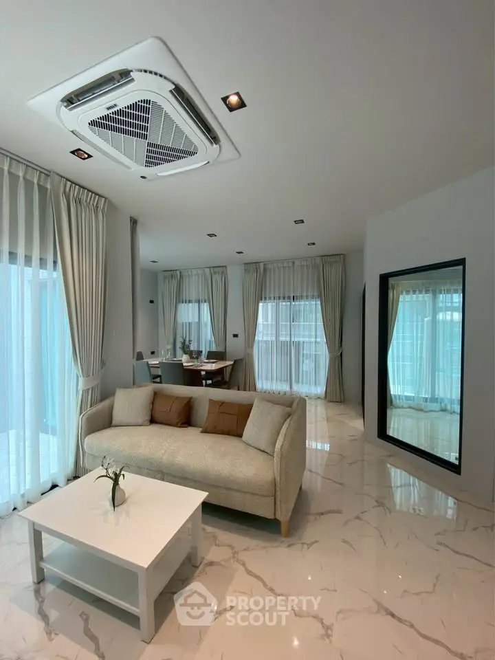 Spacious modern living room with elegant decor and large windows