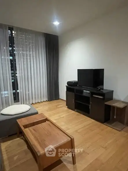 Modern living room with wooden flooring and sleek furniture