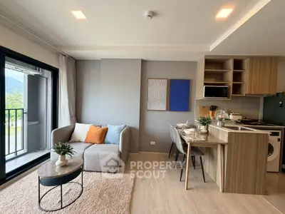 Modern living room with open kitchen and balcony view