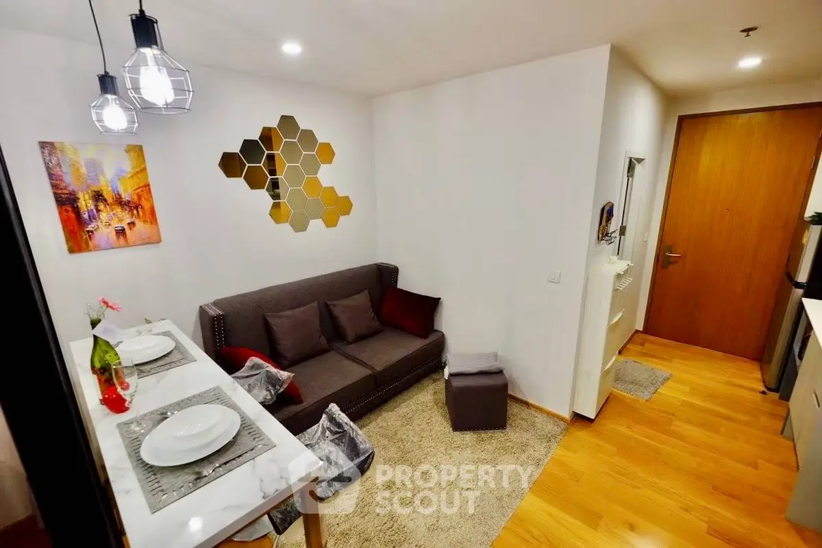 Modern living room with stylish decor and open layout, featuring cozy seating and elegant lighting.